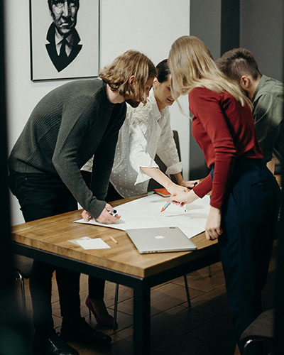 A group of people collaborating on a project through positive communication strategies A group of people collaborating on a project through positive communication strategies