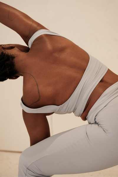 A woman stretches before bed working toward accumulated progress A woman stretches before bed working toward accumulated progress