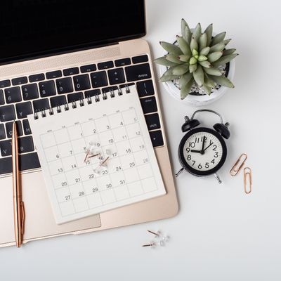A calendar, laptop, and clock on a desk to combine digital and physical time management for extending the time horizon when dealing with executive functioning challenges like ADHD A calendar, laptop, and clock on a desk to combine digital and physical time management for extending the time horizon when dealing with executive functioning challenges like ADHD