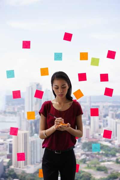A woman stand with a wall of post it notes floating behind her hinting at many nagging tasks A woman stand with a wall of post it notes floating behind her hinting at many nagging tasks