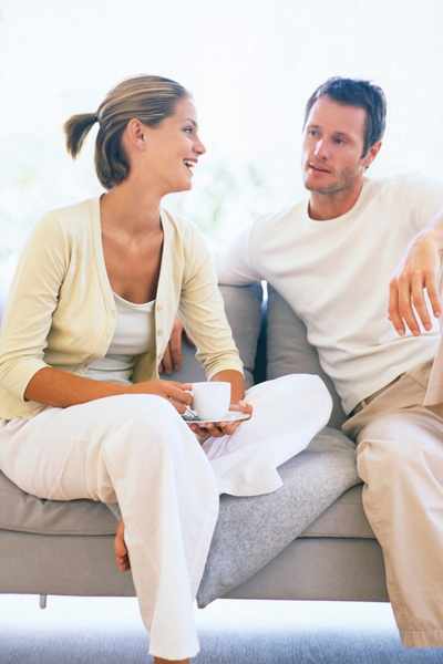 A couple talking on a couch A couple talking on a couch