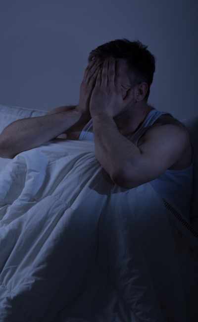A man struggles to fall asleep because of racing thoughts and an overactive mind A man struggles to fall asleep because of racing thoughts and an overactive mind
