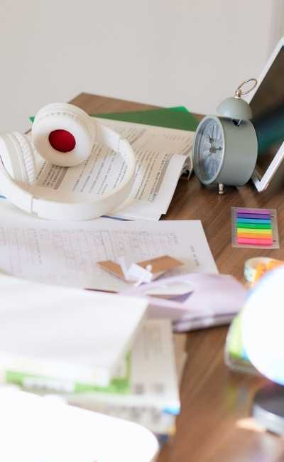 Cluttered Study Desk with Headphones and Clock Cluttered Study Desk with Headphones and Clock