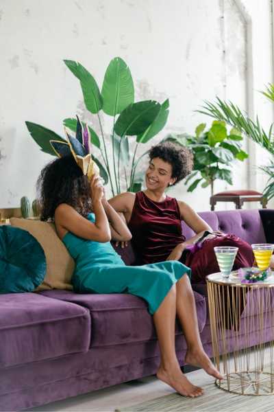 Friends Sitting Together on a Purple Couch Friends Sitting Together on a Purple Couch