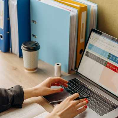 A color coded spreadsheet is open on a laptop