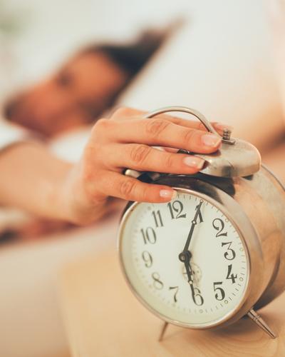 Waking up and turning off an alarm while resetting sleep schedule after the holidays