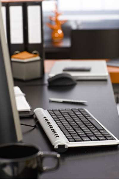 A tidy desktop cleared once a week as part of a weekly reset routine to support executive functioning