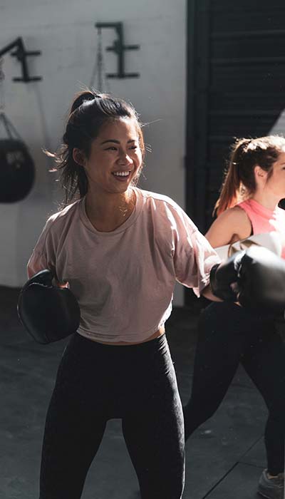 A woman doing some light boxing exercise to help her regulate her internal state for better executive function