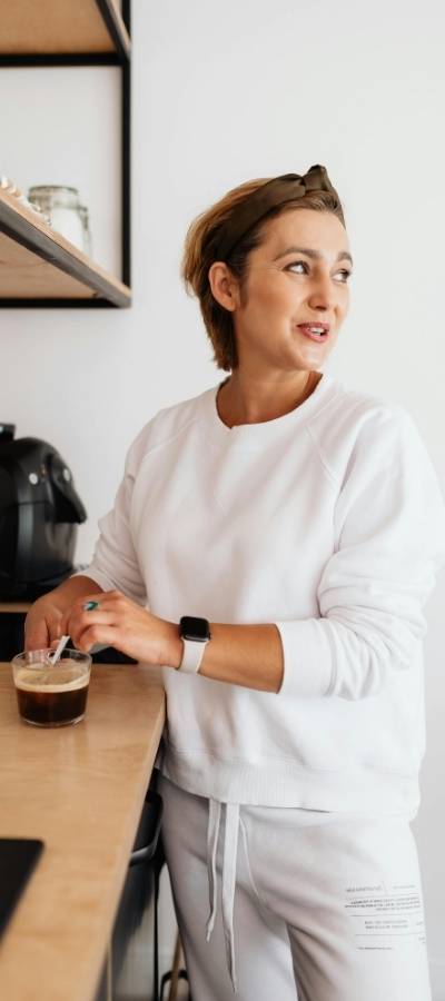 A woman makes coffee as part of her morning activation to help with task initiation and executive function