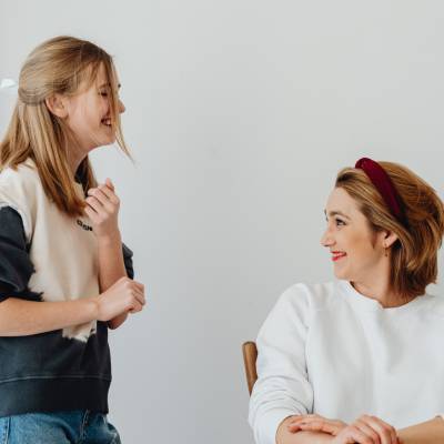 A mother and daughter smiling together enjoying a positive moment thanks to emotional resilience built through Broaden and Build techniques