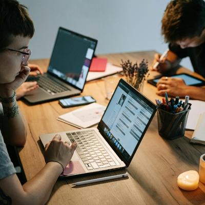 A group of people using body doubling for productivity while doing separate tasks